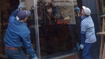 Two installers setting a large pane of glass