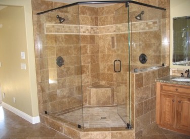 Frameless glass shower enclosure in a tiled bathroom